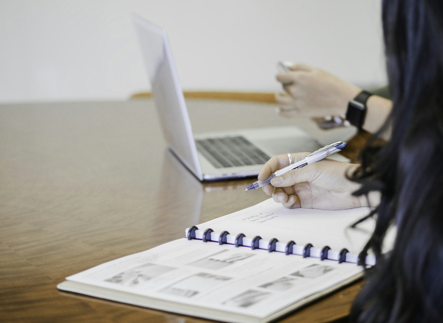 a man sitting at a desk talking on a phone